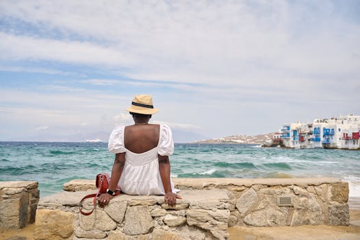 Back View of a Woman Sitting by the Sea